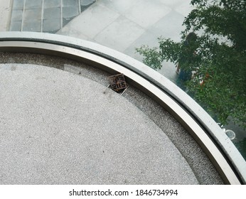 Top View Of Bending Temper Laminated Glass With Curve Bottom Fitting On Gravel Finished Floor And A Floor Drain. 