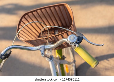 Top View Of Bicycle Handlebar With Brown Basket.