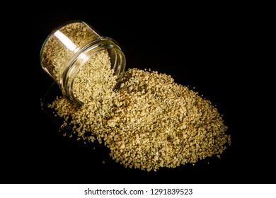 top view big green natural organic sea salt poured out from small glass jar on black mirror background - Shutterstock ID 1291839523