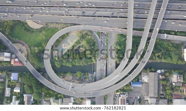 Top view/ Bird eye view of busy circular highway\
in Bangkok, Thailand