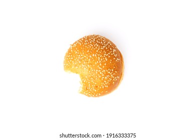 Top View Of Bitten Bun With Sesame Seeds Isolated On White Background.