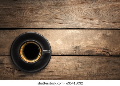 Top View Of A Black Coffee Cup On Wood Background.