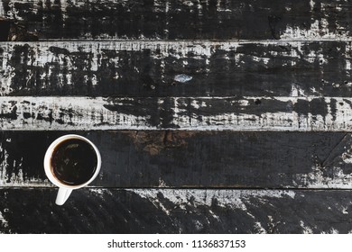 Top view black coffee in white cup on wooden table.