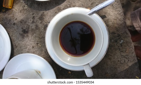 Top view of black coffee in white cup with spoon - Shutterstock ID 1535449034