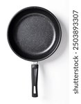 Top view Black frying pan with a non-stick coating isolated on white background