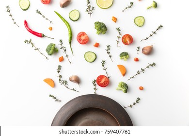 Top View Of Black Plate And Cut Vegetables Isolated On White