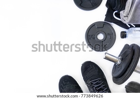 Top view of black tone fitness accessories on white background with copy space, equipment for weight training exercises concept