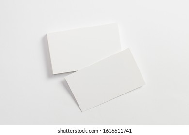 Top View Of Blank Business Cards Isolated On White. Mock-up To Showcase Your Design.