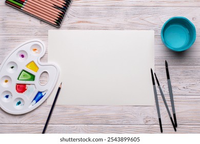 Top View of Blank Canvas with Art Supplies on White Wooden Table - Powered by Shutterstock