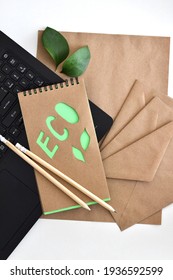 Top View Of Blank Kraft Paper Sheet With Green Branch, Notebook And KRAFT Envelopes. Office Eco Friendly, Home Office Desktop Organisation, Work From Home. 