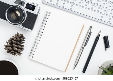 Top View Of Blank Notebook Page On White Photographer Table, Travel Planning Concept. Top View, Flat Lay.