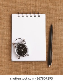 Top View Of Blank Notepad For Todo List With Pen And Clock