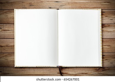 Top view of blank open notebook page on wood background office desk with little tree. Minimal flat lay style