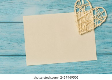 Top view blank paper with heart on a blue wooden background - Powered by Shutterstock