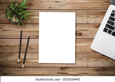 Top View Of Blank Paper Page On Wood Background Office Desk And Different Objects. Minimal Flat Lay Style