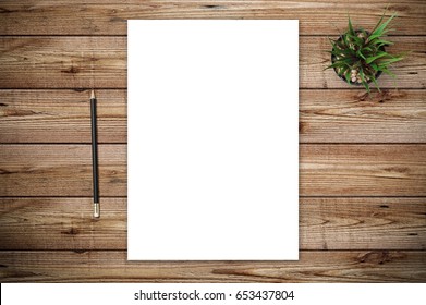 Top View Of Blank Paper Page On Wood Background Office Desk With Different Objects. Minimal Flat Lay Style