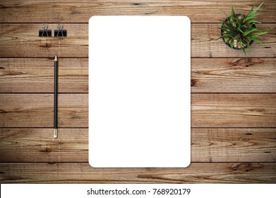 Top View Of Blank Paper Page On Wood Background Office Desk With Different Objects. Minimal Flat Lay Style