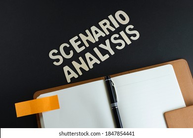 Top View Of Block Letters On Scenario Analysis With A Pen On Empty Notebook On A Black Background 