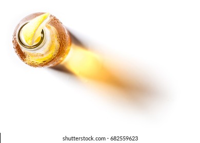 Top view of a blonde beer bottle with lemon inside on white background - Shutterstock ID 682559623
