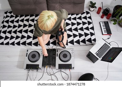 Top View Of The Blonde Female Music Producer Feeling Pleasure To Finish Project In Her Flat. Music Production, Broadcasting, Post Production Concept