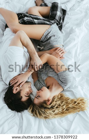 Similar – Happy young couple in love kissing under duvet cover