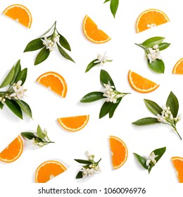 Top view of blossoming branches of orange tree with leaves and sliced orange fruit, isolated on white background.