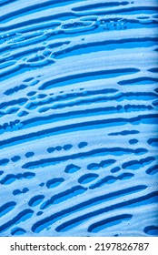 Top View Of A Blue Glass Surface Covered With Soap Foam. Monochromatic Background Without People, Concept Of Cleanliness.