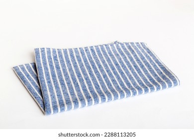 top view with blue kitchen napkin isolated on table background. Folded cloth for mockup with copy space, Flat lay. Minimal style.