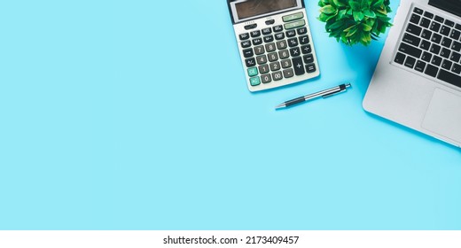 Top View, Blue Office Desk With Computer, Pen And Calculator, Copy Space, Mock Up..	