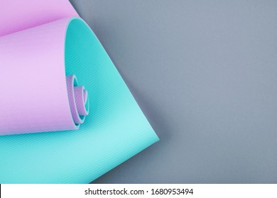 Top View Of Blue Pink Yoga Mat On Grey Background. Yoga Pilates Sport Concept. Flat Lay. 