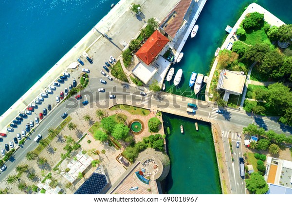 Top view of a boat\
mooring and car parking
