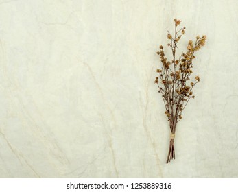 Top view bouquet of dried and wilted brown Gypsophila flowers on matt marble background with copy space - Shutterstock ID 1253889316