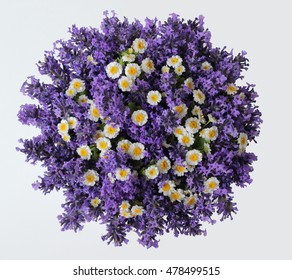 Top View Of A Bouquet Of Lavender And Camomile Flowers On A White Background. Colorful Summer Bouquet Of Purple Lavender And Yellow Chamomile Flowers. Photo From Above.