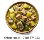 Top view of a bowl of green chile stew with chunks of pork and potatoes, isolated on white background.