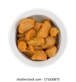 A Top View Of A Bowl Of Naturally Moist And Tasty Canned  Yams On A White Background.