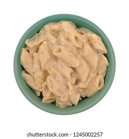 Top View Of A Bowl Of Pasta With Chicken In An Alfredo Sauce Isolated On A White Background.