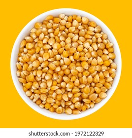 Top view of bowl with Popcorn Kernels Uncooked. Popcorn Kernels Uncooked in a Ceramic Bowl. The image is a cut out, isolated on a white background, with a clipping path