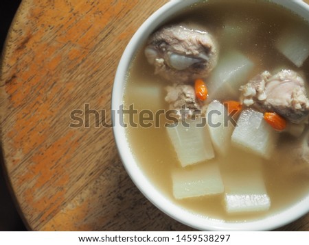 Top view bowl of white radish soup with pork bone and goji berry. Stock photo © 