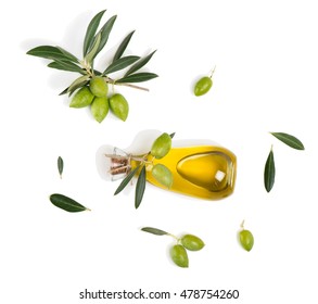 Top View Of Branch With Green Olives And A Bottle Of Olive Oil Isolated On White Background.