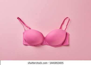 top view of brassiere on pink background, breast cancer concept