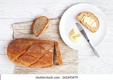 Top View Of Bread With Butter On White Table