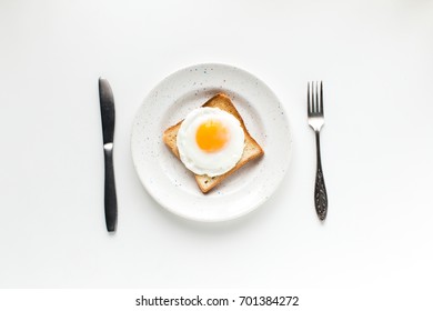 Top View Of Breakfast With Fried Egg On Toast, Isolated On White