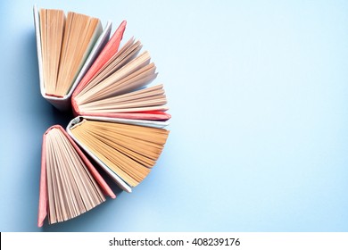 Top View Of Bright Colorful Hardback Books In A Circle. Open Book, Fanned Pages.   Education Essential For Self Improvement, Gaining Knowledge And Success In Our Careers, Business And Personal Lives.