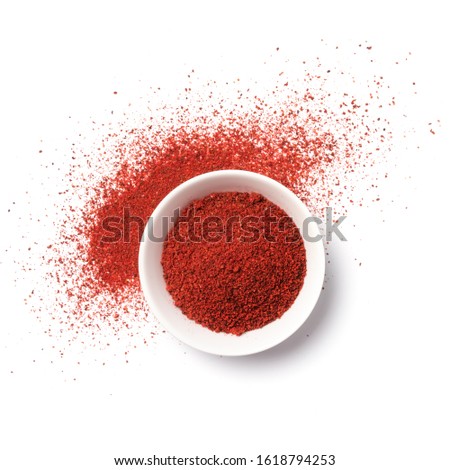 Top view of bright paprika powder in bowl for aromatic food isolated on white background