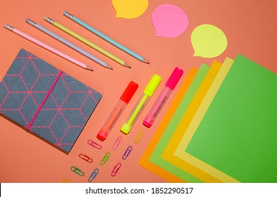 Top View Of Bright Stationery Pieces On The Oramge Surface.Organized Office Supplies