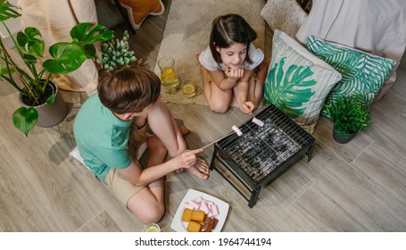 Top View Of Brothers Camping At Home Toasting Marshmallows To Make Smores