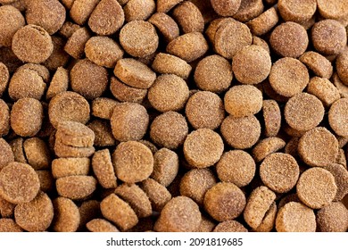 Top View Of Brown Kibble Pieces Of Dry Dog Food As A Textured Pattern