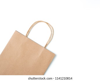 Top View Brown Paper Shopping Bag On White Background, Mock-up Of Blank Brown Paper Shopping Bag And Copy Space. Flat Lay.