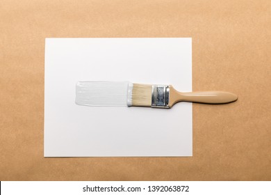 Top View Of Brush And Paper Isolated On Brown