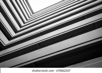 Top View Building, Looking Up To Cement Building. Modern Architecture, Cement Abstract Architectural Design. Inspirational, Artistic Image. Industrial Design. .Modern Building. Black And White.